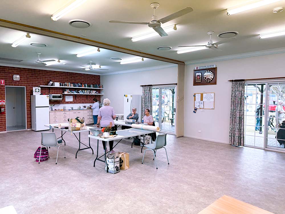 Meeting room showing kitchenette facilities in the background